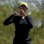
              Oregon golfer Tze-Han Lin shapes an "O" to her teammates on the first green during the NCAA college women's golf championship title match at Grayhawk Golf Club against Stanford, Wednesday, May 25, 2022, in Scottsdale, Ariz. (AP Photo/Matt York)
            