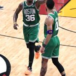 
              Boston Celtics guard Marcus Smart (36) and forward Jayson Tatum (0) celebrate after scoring during the first half of Game 7 of the NBA basketball Eastern Conference finals playoff series against the Miami Heat, Sunday, May 29, 2022, in Miami. (AP Photo/Wilfredo Lee)
            