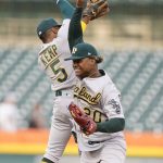 
              Oakland Athletics second baseman Tony Kemp (5) and center fielder Cristian Pache (20) high-five each other after the ninth inning of the second baseball game of a doubleheader against the Detroit Tigers, Tuesday, May 10, 2022, in Detroit. (AP Photo/Carlos Osorio)
            