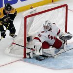 
              Boston Bruins' Chris Wagner (14) comes around the net to shoot against Carolina Hurricanes' Pyotr Kochetkov (52) during the second period of Game 3 of an NHL hockey Stanley Cup first-round playoff series, Friday, May 6, 2022, in Boston. (AP Photo/Michael Dwyer)
            