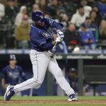 
              Tampa Bay Rays' Manuel Margot hits a three-run home run in the ninth inning of a baseball game against the Seattle Mariners, Friday, May 6, 2022, in Seattle. The Rays won 8-7. (AP Photo/Jason Redmond)
            