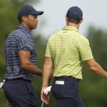 
              Tiger Woods and Rory McIlroy, of Northern Ireland, walk on the 13th hole during the first round of the PGA Championship golf tournament Thursday, May 19, 2022, in Tulsa, Okla. (AP Photo/Matt York)
            
