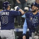 
              Tampa Bay Rays' Mike Zunino (10) is greeted at the dugout by Kevin Kiermaier, right, after hitting a three-run home run during the fourth inning of a baseball game against the Seattle Mariners, Thursday, May 5, 2022, in Seattle. (AP Photo/Ted S. Warren)
            