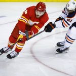 
              Edmonton Oilers left wing Evander Kane, right, defends as Calgary Flames defenseman Rasmus Andersson turns with the puck during the second period of Game 1 of an NHL hockey second-round playoff series Wednesday, May 18, 2022, in Calgary, Alberta. (Jeff McIntosh/The Canadian Press via AP)
            