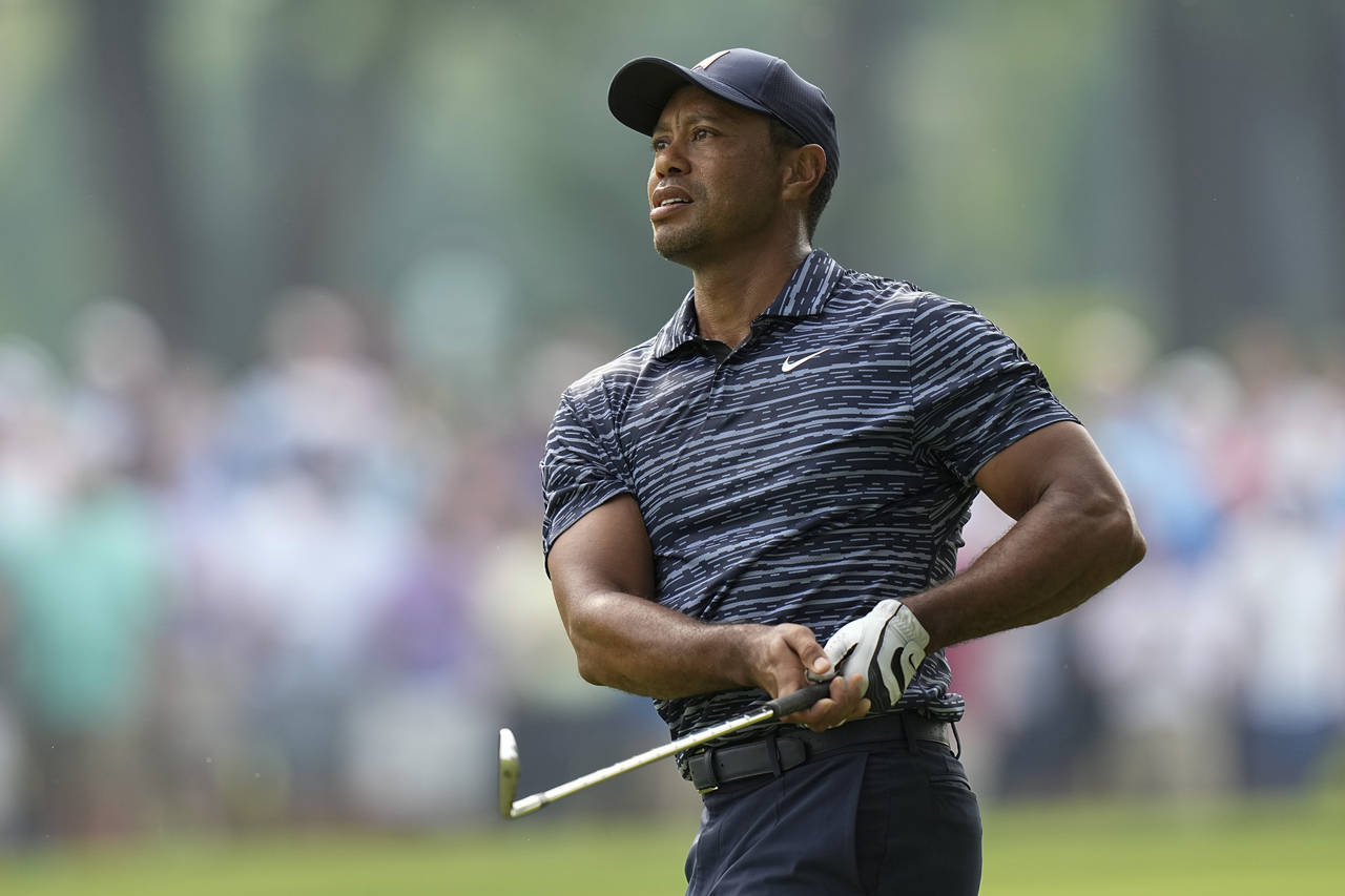 Tiger Woods hits from the fairway on the 13th hole during the first round of the PGA Championship g...