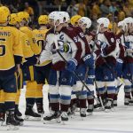 
              Colorado Avalanche left wing Gabriel Landeskog (92) leads the Avalanche as they shake hands with the Nashville Predators after Game 4 of an NHL hockey first-round playoff series Monday, May 9, 2022, in Nashville, Tenn. The Avalanche won 5-3 to sweep the series 4-0. (AP Photo/Mark Humphrey)
            
