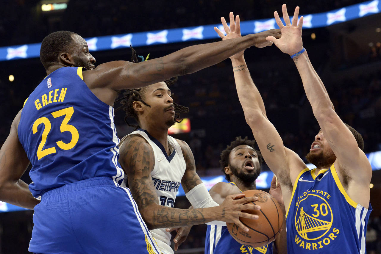 Memphis Grizzlies guard Ja Morant, second from left, handles the ball against Golden State Warriors...