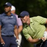 
              Rory McIlroy, of Northern Ireland, watches his tee shot as Tiger Woods looks on, on the 17th hole during the first round of the PGA Championship golf tournament, Thursday, May 19, 2022, in Tulsa, Okla. (AP Photo/Eric Gay)
            