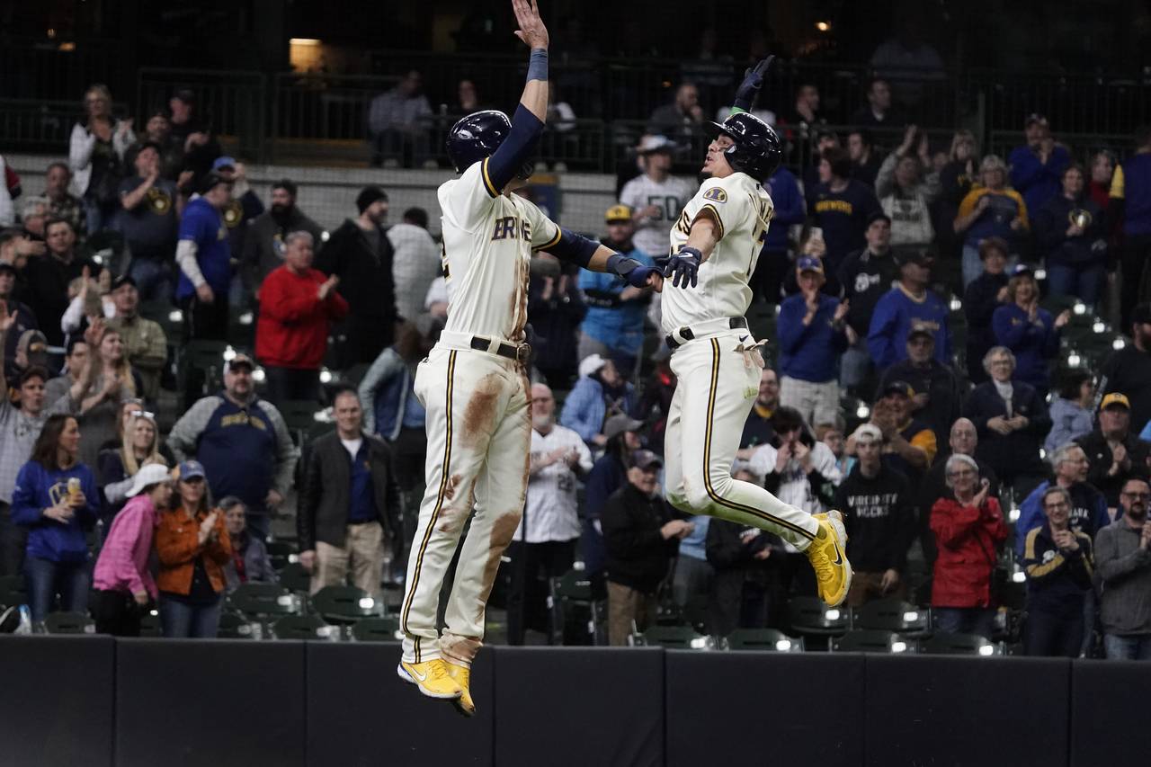 Milwaukee Brewers' Willy Adames celebrates with Christian Yelich after hitting a two-run home run d...