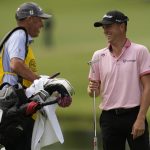 
              Justin Thomas celebrates after a birdie with his caddie on the 11th hole during the final round of the PGA Championship golf tournament at Southern Hills Country Club, Sunday, May 22, 2022, in Tulsa, Okla. (AP Photo/Matt York)
            