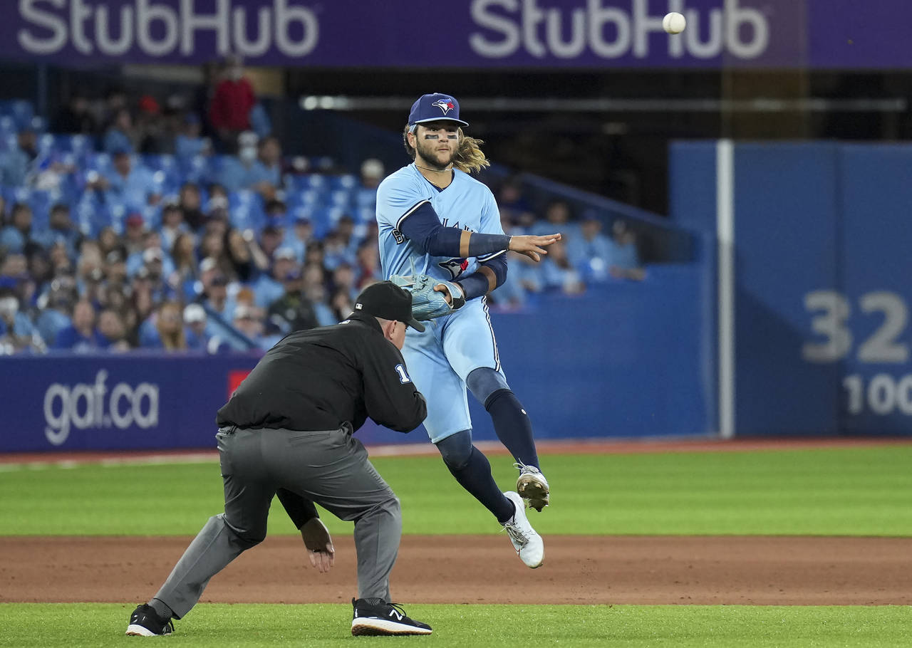 Toronto Blue Jays shortstop Bo Bichette (11) makes a jumping throw to out Seattle Mariners first ba...