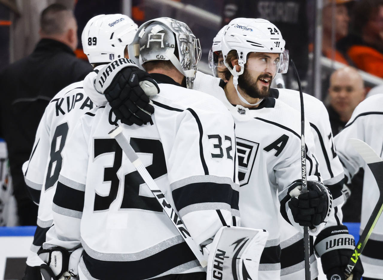 Los Angeles Kings centre Phillip Danault, right, hugs goalie Jonathan Quick after defeating the Edm...