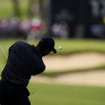 
              Tiger Woods hits from the fairway on the 17th hole during the first round of the PGA Championship golf tournament, Thursday, May 19, 2022, in Tulsa, Okla. (AP Photo/Eric Gay)
            