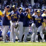 
              The Milwaukee Brewers Andrew McCutchen (24), Kolten Wong (16) and Luis Urias (2) celebrate with teammates after their win over the Chicago Cubs in the first game of a baseball doubleheader Monday, May 30, 2022, in Chicago. (AP Photo/Charles Rex Arbogast)
            