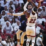 
              Miami Heat forward Jimmy Butler (22) aims to score as Philadelphia 76ers forward Tobias Harris (12) defends during the first half of Game 2 of an NBA basketball second-round playoff series, Wednesday, May 4, 2022, in Miami. (AP Photo/Marta Lavandier)
            