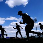 
              FILE - Quad Cities River Bandits players warm up before a Class-A Midwest League baseball game against the Cedar Rapids Kernels in Cedar Rapids, Iowa, Monday, May 13, 2019. Minor league players and Major League Baseball have reached a settlement in a lawsuit alleging teams violated minimum wage laws. The settlement has not yet been filed with the court and details were not released Tuesday, May 10, 2022. (AP Photo/Charlie Neibergall, File)
            