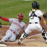 
              Cincinnati Reds' Kyle Farmer (17) slides home to score on a sacrifice fly by TJ Friedl as Pittsburgh Pirates catcher Michael Perez (5) awaits the throw from left fielder Ben Gamel during the third inning of a baseball game, Friday, May 13, 2022, in Pittsburgh. (AP Photo/Keith Srakocic)
            