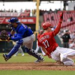 
              Chicago Cubs' Willson Contreras, left, fields the ball as Cincinnati Reds' Tyler Stephenson scores a run on single by Albert Almora Jr. during the third inning of a baseball game in Cincinnati, Thursday, May 26, 2022. (AP Photo/Aaron Doster)
            