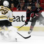 
              Carolina Hurricanes' Tony DeAngelo (77) prepares to shoot the puck past Boston Bruins' Charlie McAvoy (73) during the second period of Game 1 of an NHL hockey Stanley Cup first-round playoff series in Raleigh, N.C., Monday, May 2, 2022. (AP Photo/Karl B DeBlaker)
            
