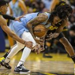 
              Memphis Grizzlies guard Ja Morant dribbles the ball as he is defended by Golden State Warriors guard Jordan Poole, left, and forward Andrew Wiggins during the fourth quarter in Game 3 of an NBA basketball playoffs Western Conference semifinal, Saturday, May 7, 2022. (Stephen Lam/San Francisco Chronicle via AP)
            