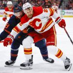 
              Calgary Flames forward Trevor Lewis, right, holds back Edmonton Oilers winger Zach Hyman during the third period of Game 4 of an NHL hockey Stanley Cup playoffs second-round series Tuesday, May 24, 2022, in Edmonton, Alberta. (Jeff McIntosh/The Canadian Press via AP)
            