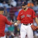 
              Boston Red Sox starting pitcher Nathan Eovaldi, right, hands the ball to manager Alex Cora during the second inning of the team's baseball game against the Houston Astros at Fenway Park, Tuesday, May 17, 2022, in Boston. Eovaldi allowed nine runs, six earned, in the second inning. (AP Photo/Charles Krupa)
            