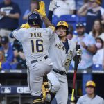 
              Milwaukee Brewers' Kolten Wong (16) celebrates his home run withWilly Adames (27) during the first inning of the team's baseball game against the Miami Marlins, Friday, May 13, 2022, in Miami. (AP Photo/Jim Rassol)
            