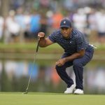 
              Tiger Woods lines up a putt on the 11th hole during the first round of the PGA Championship golf tournament, Thursday, May 19, 2022, in Tulsa, Okla. (AP Photo/Eric Gay)
            
