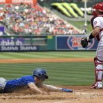 
              Toronto Blue Jays' Cavon Biggio, left, scores on a double by Lourdes Gurriel Jr. as Los Angeles Angels catcher Max Stassi, right, stands at the plate during the second inning of a baseball game Sunday, May 29, 2022, in Anaheim, Calif. (AP Photo/Mark J. Terrill)
            