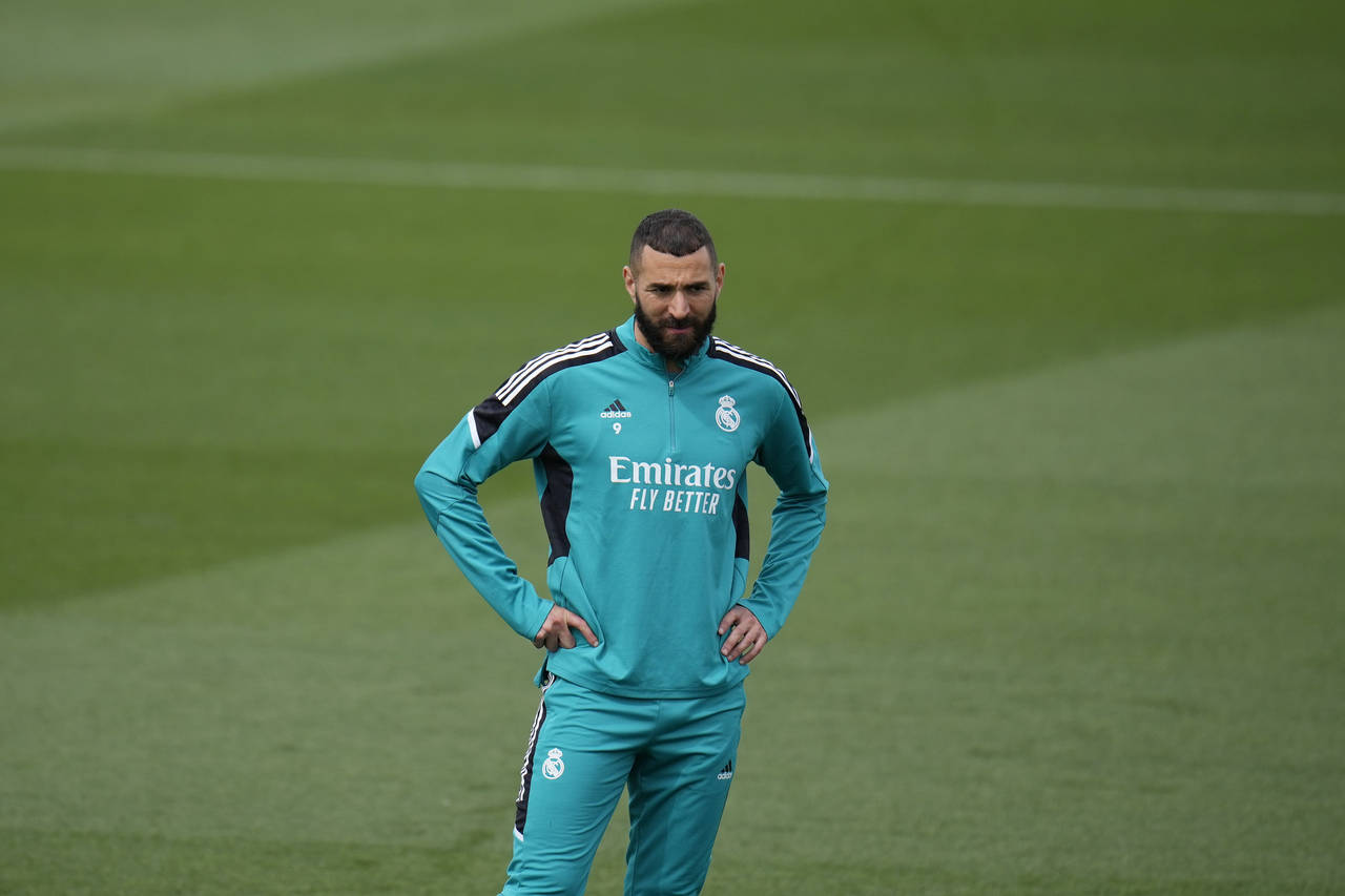 Real Madrid's Karim Benzema stands on the pitch during a Media Opening day training session in Madr...