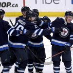 
              Winnipeg Jets' Paul Stastny (25) celebrates his 800th career point with an assist on Blake Wheeler's (26) goal against the Seattle Kraken during the third period of NHL hockey game action in Winnipeg, Manitoba, Sunday, May 1, 2022. (Fred Greenslade/The Canadian Press via AP)
            