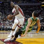 
              Miami Heat center Bam Adebayo (13) runs into Boston Celtics forward Grant Williams (12) during the second half of Game 1 of an NBA basketball Eastern Conference finals playoff series, Tuesday, May 17, 2022, in Miami. (AP Photo/Lynne Sladky)
            