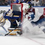 
              St. Louis Blues goaltender Ville Husso, left, stops a shot from Colorado Avalanche's Logan O'Connor (25) during the first period in Game 4 of an NHL hockey Stanley Cup second-round playoff series Monday, May 23, 2022, in St. Louis. (AP Photo/Jeff Roberson)
            