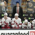 
              Carolina Hurricanes head coach Rod Brind'Amourin, top, and members of the team watch as the Hurricanes trail the Boston Bruins in the third period of Game 4 of an NHL hockey Stanley Cup first-round playoff series, Sunday, May 8, 2022, in Boston. (AP Photo/Steven Senne)
            