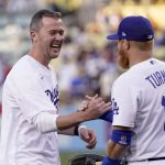 
              University of Southern California football head coach Lincoln Riley, left, shakes hands with Los Angeles Dodgers third baseman Justin Turner after throwing out the ceremonial first pitch prior to a baseball game between the Dodgers and the Philadelphia Phillies Friday, May 13, 2022, in Los Angeles. (AP Photo/Mark J. Terrill)
            