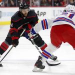 
              Carolina Hurricanes' Vincent Trocheck (16) moves the puck to challenge New York Rangers' Justin Braun (61) during the second period of Game 7 of an NHL hockey Stanley Cup second-round playoff series in Raleigh, N.C., Monday, May 30, 2022. (AP Photo/Karl B DeBlaker)
            