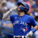 
              Toronto Blue Jays' Bo Bichette (11) celebrates his solo home run against the Cincinnati Reds during the fourth inning of a baseball game in Toronto, Saturday, May 21, 2022.  (Frank Gunn/The Canadian Press via AP)
            