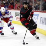 
              Carolina Hurricanes' Vincent Trocheck (16) controls the puck in front of New York Rangers' K'Andre Miller (79) during the second period of Game 1 of an NHL hockey Stanley Cup second-round playoff series in Raleigh, N.C., Wednesday, May 18, 2022. (AP Photo/Karl B DeBlaker)
            