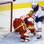 
              Edmonton Oilers center Connor McDavid, right, scores on Calgary Flames goalie Jacob Markstrom during the second period of Game 2 of an NHL hockey Stanley Cup playoffs second-round series Friday, May 20, 2022, in Calgary, Alberta. (Jeff McIntosh/The Canadian Press via AP)
            