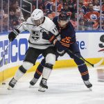 
              Los Angeles Kings' Anze Kopitar (11) and Edmonton Oilers' Darnell Nurse (25) battle for the puck during the third period of Game 1 of an NHL hockey Stanley Cup first-round playoff series, Monday, May 2, 2022 in Edmonton, Alberta. (Jason Franson/The Canadian Press via AP)
            