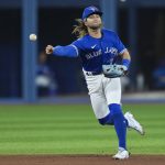 
              Toronto Blue Jays shortstop Bo Bichette throws to first after bobbling a ball hit by New York Yankees' Giancarlo Stanton, who was safe during the seventh inning of a baseball game Tuesday, May 3, 2022, in Toronto. (Nathan Denette/The Canadian Press via AP)
            