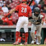
              Pittsburgh Pirates catcher Josh VanMeter, right, reacts as he attempts to field the ball behind Cincinnati Reds' Tommy Pham during the first baseball game of a doubleheader in Cincinnati, Saturday, May 7, 2022. The Reds won 9-2. (AP Photo/Aaron Doster)
            