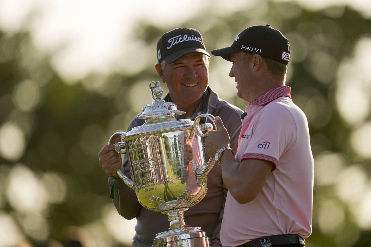 Justin Thomas poses with the Wanamaker Trophy with his dad Mike, after winning the PGA Championship...
