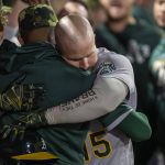 
              Oakland Athletics' Seth Brown, right, gets a hug in the dugout hitting a two-run home run against the Los Angeles Angels during the fifth inning of a baseball game in Anaheim, Calif., Friday, May 20, 2022. (AP Photo/Alex Gallardo)
            
