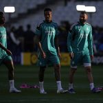 
              Real Madrid's Vinicius Junior, left, Real Madrid's Eder Militao, center, and Real Madrid's Karim Benzema gesture during a training session at the Stade de France in Saint Denis near Paris, Friday, May 27, 2022. Liverpool and Real Madrid are making their final preparations before facing each other in the Champions League final soccer match on Saturday. (AP Photo/Manu Fernandez)
            