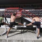 
              Ukraine athletes stretch their muscles ahead of a training session at Elbasan Arena stadium in Elbasan, about 45 kilometers (30 miles) south of Tirana, Albania, Monday, May 9, 2022. After fleeing from a war zone, a group of young Ukrainian track and field athletes have made their way to safety in Albania. Their minds are still between the two countries. (AP Photo/Franc Zhurda)
            