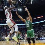 
              Miami Heat forward Jimmy Butler (22) aims to score as Boston Celtics forward Grant Williams (12) defends during the second half of Game 2 of the NBA basketball Eastern Conference finals playoff series, Thursday, May 19, 2022, in Miami. (AP Photo/Lynne Sladky)
            