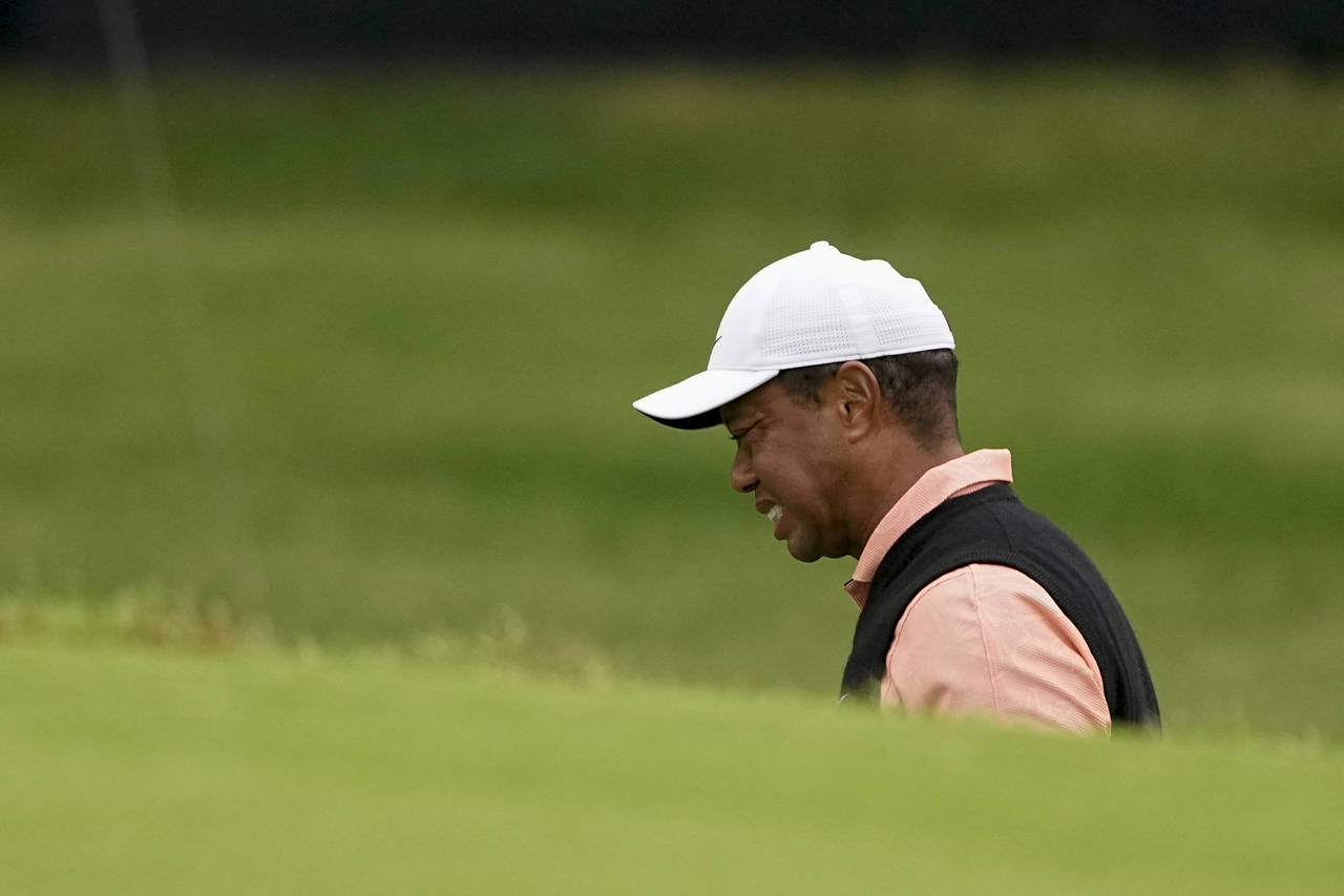 Tiger Woods grimaces on the 18th hole during the third round of the PGA Championship golf tournamen...