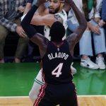 
              Boston Celtics forward Jayson Tatum, top, looks to pass while pressured by Miami Heat guard Victor Oladipo (4) during the second half of Game 4 of the NBA basketball playoffs Eastern Conference finals, Monday, May 23, 2022, in Boston. (AP Photo/Charles Krupa)
            
