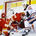 
              Edmonton Oilers winger Jesse Puljujarvi, right, has the net blocked by Calgary Flames goalie Jacob Markstrom during the second period of Game 5 of an NHL hockey second-round playoff series Thursday, May 26, 2022, in Calgary, Alberta. (Jeff McIntosh/The Canadian Press via AP)
            